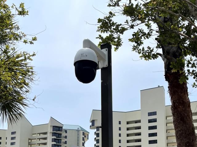 Advanced dome camera installation for 360-degree monitoring in a shaded outdoor location.