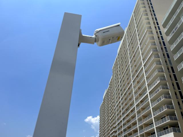 High-rise surveillance setup featuring a premium camera overlooking an expansive skyline.